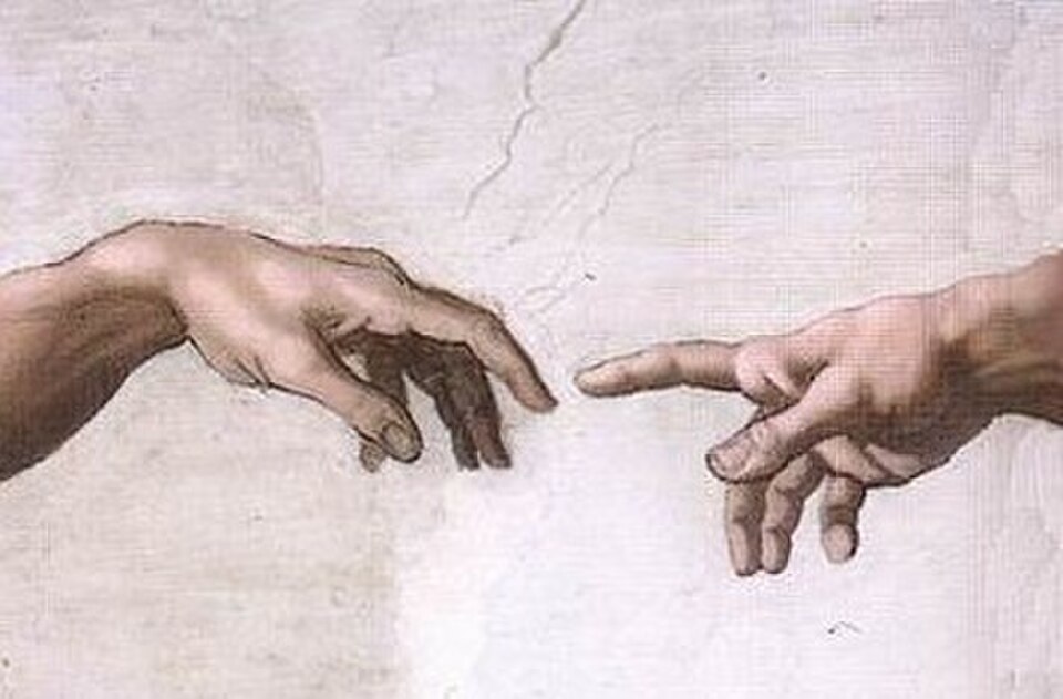 Detail of Michelangelo's Creation of Adam, the hands of God and Adam almost touching.